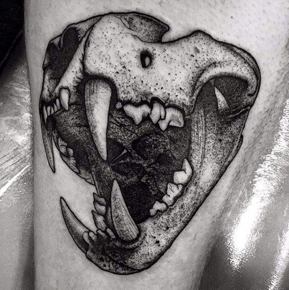 Big dot style tattoo of animal skull with big teeth