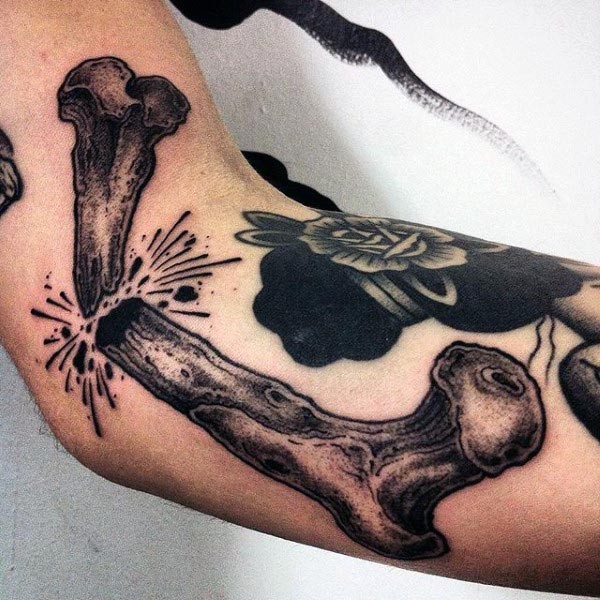Big engraving style black ink arm tattoo of broken bone