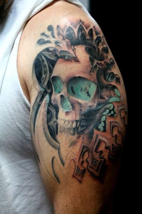 Big fantasy style colored shoulder tattoo of human skull