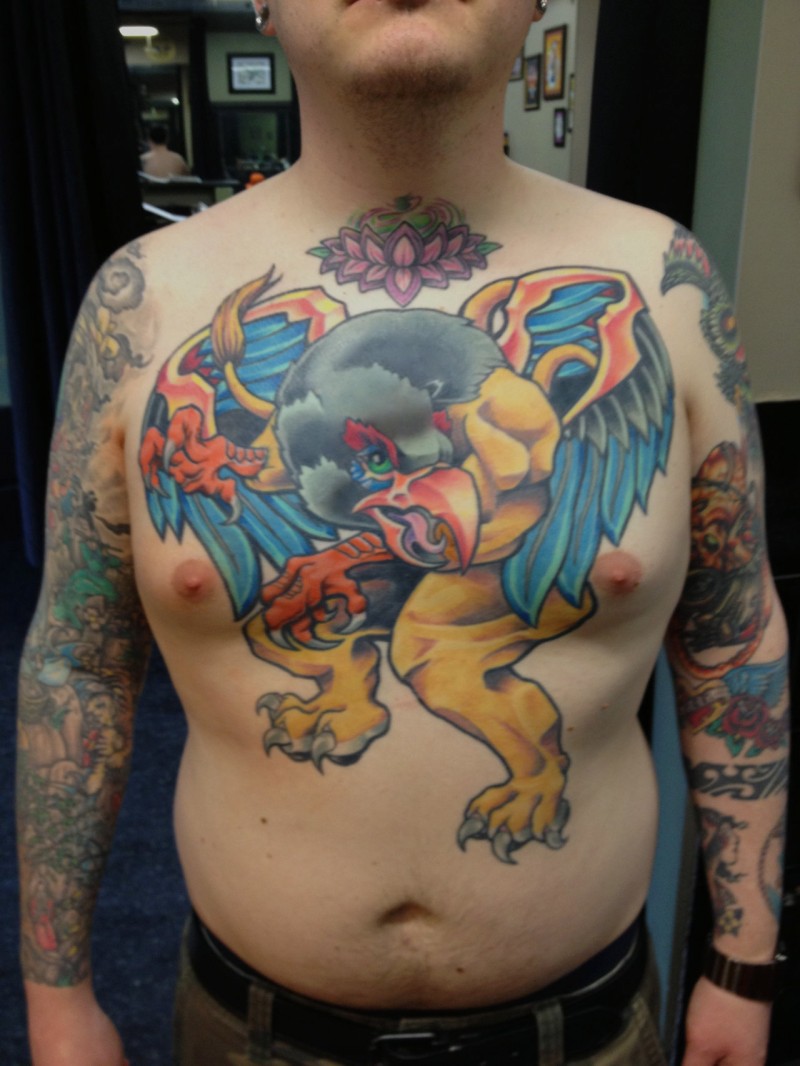 Big griffin tattoo on males chest