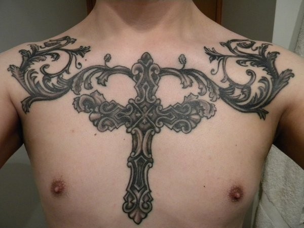 Big iron cross with patterns tattoo on chest