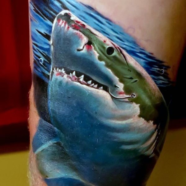 Big multicolored bloody hooked shark tattoo on leg
