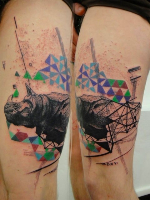 Big multicolored geometrical style tattoo on thigh combined with rhino