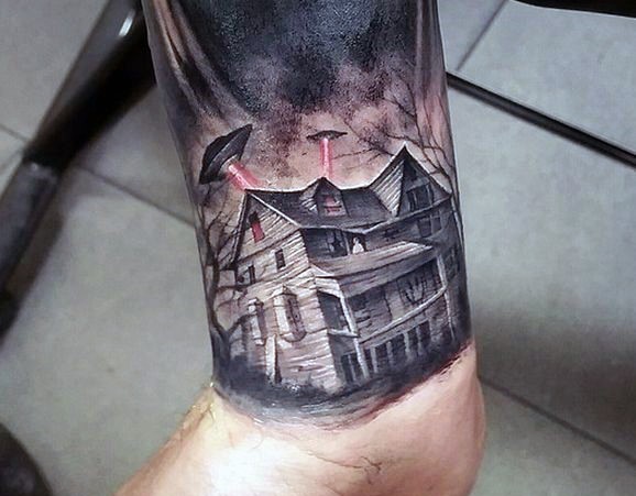 Big multicolored lonely house with alien ships tattoo on wrist