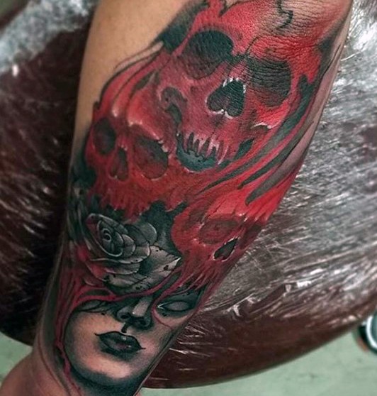Big multicolored mystical witch with skulls tattoo on arm