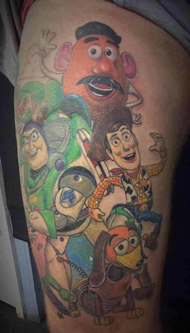 Big multicolored thigh tattoo of various Toy Story carton heroes