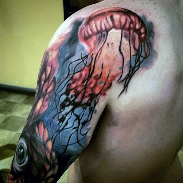 Big mystical painted and colored jellyfish tattoo on shoulder with eyeball
