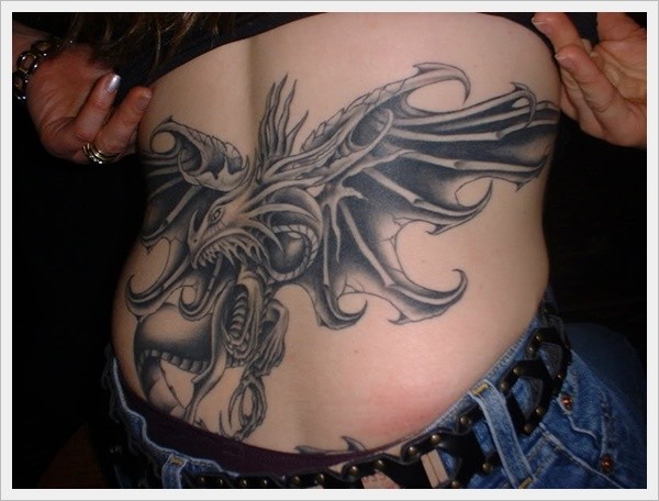 Big mythical dragon tattoo on lower back