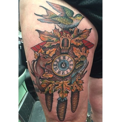 Big natural colored old school wall clock tattoo on thigh stylized with various animals and leaves