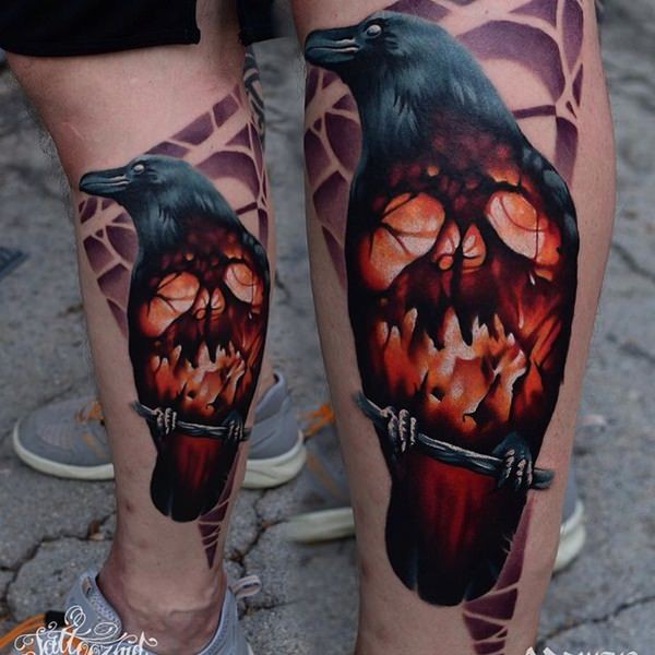 Big natural looking colored crow tattoo on leg stylized with burning skull