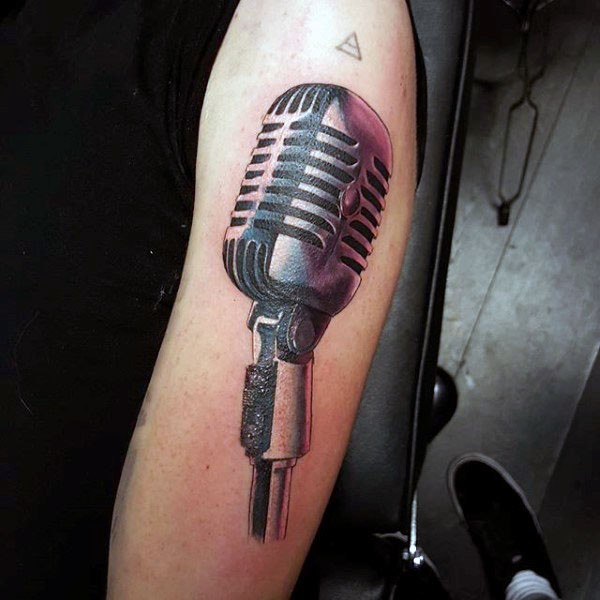 Big natural looking colored old microphone tattoo on shoulder