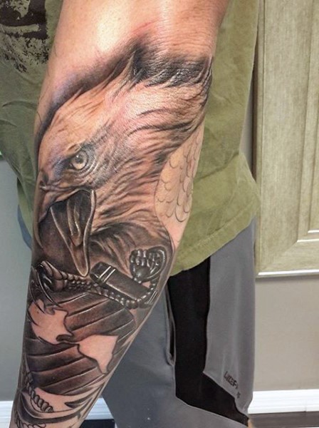 Big natural looking eagle with anchor tattoo on arm