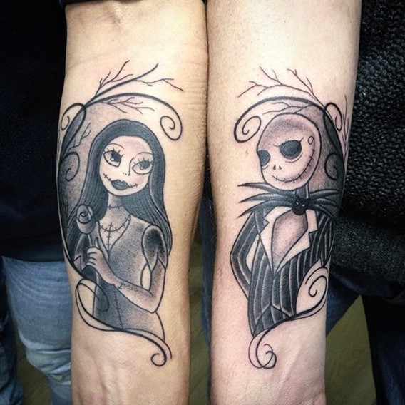 Big nice painted black ink monster cartoon heroes couple tattoo on forearms
