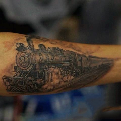 Big old detailed colored steamy train tattoo on arm