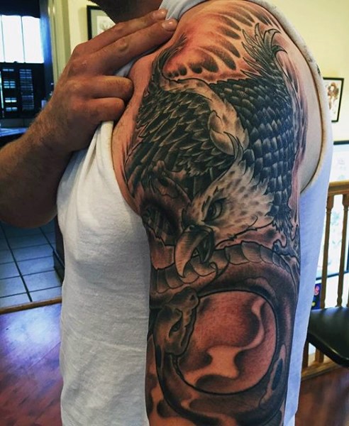 Big old school style painted colored eagle with snake tattoo on half sleeve area