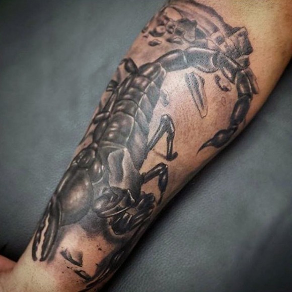 Big realistic looking black ink scorpion tattoo on arm