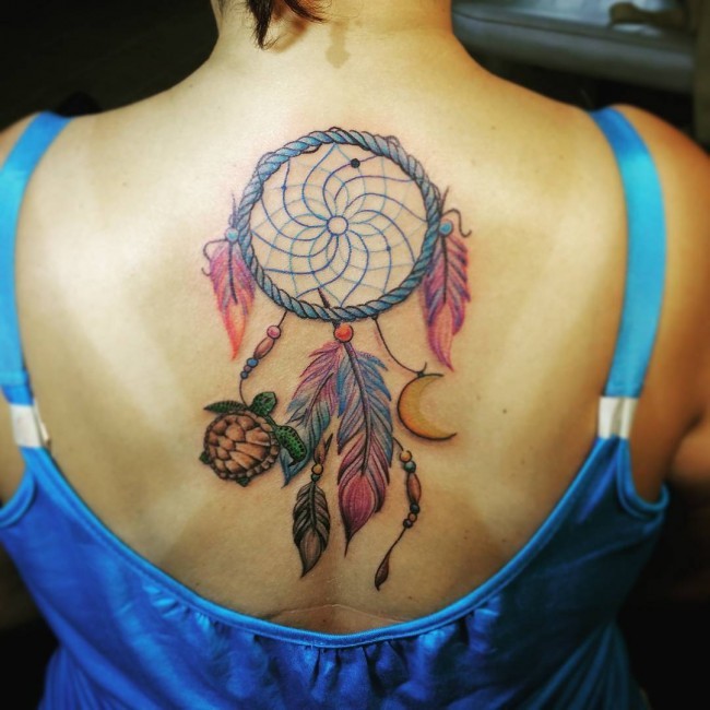 Big sweet looking colored black tattoo of turtle with dream catcher