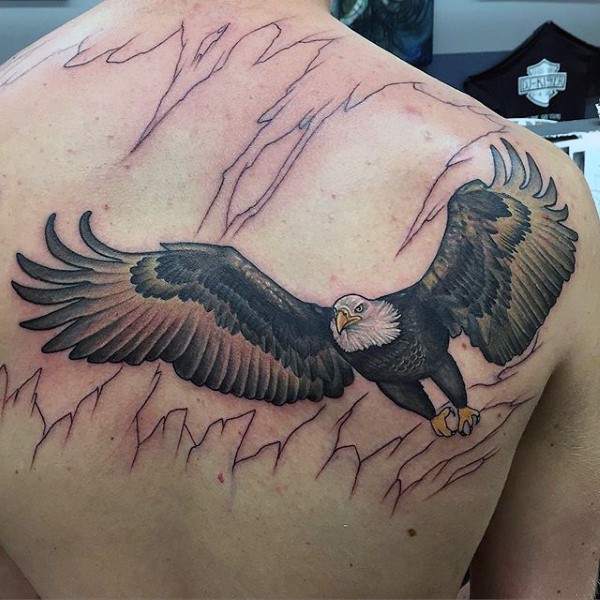 Big unfinished colorful flying eagle tattoo on upper back