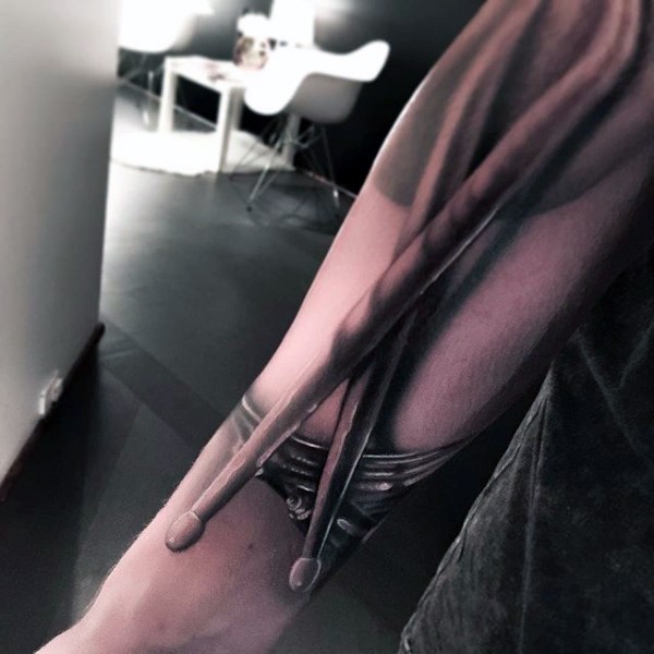 Big very detailed 3D drums sticks tattoo on arm