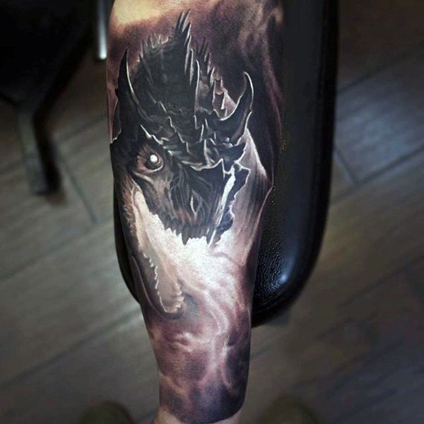 Big very detailed black and white dragon tattoo on arm