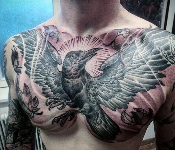Big very detailed looking black and white flying crow tattoo on chest