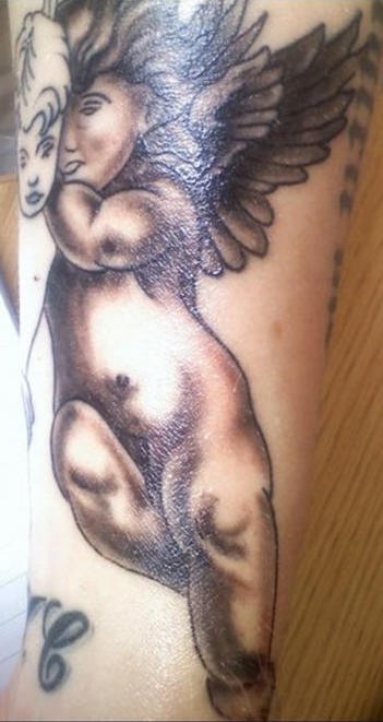 Black and gray extensive cherub tattoo