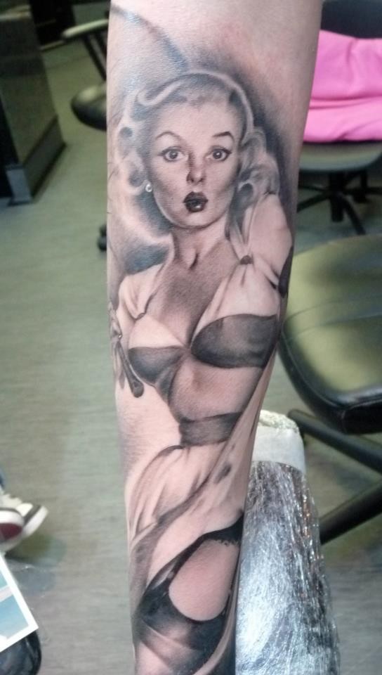 Black and gray pinup girl tattoo by Samantha Ford