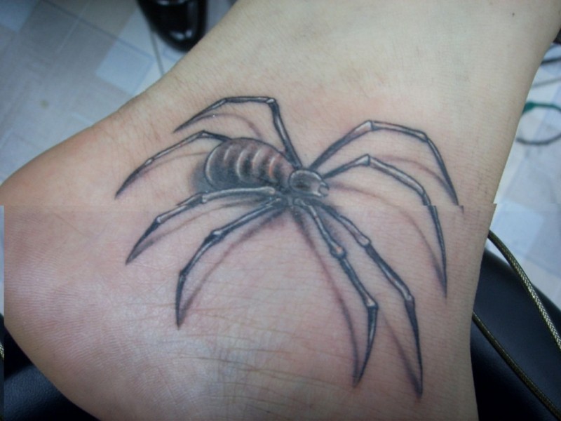 Black and gray spider tattoo on foot