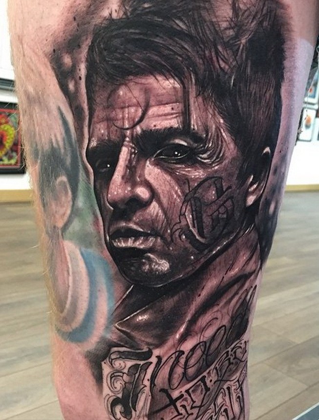 Black and gray style 3D like man portrait tattoo on thigh with lettering