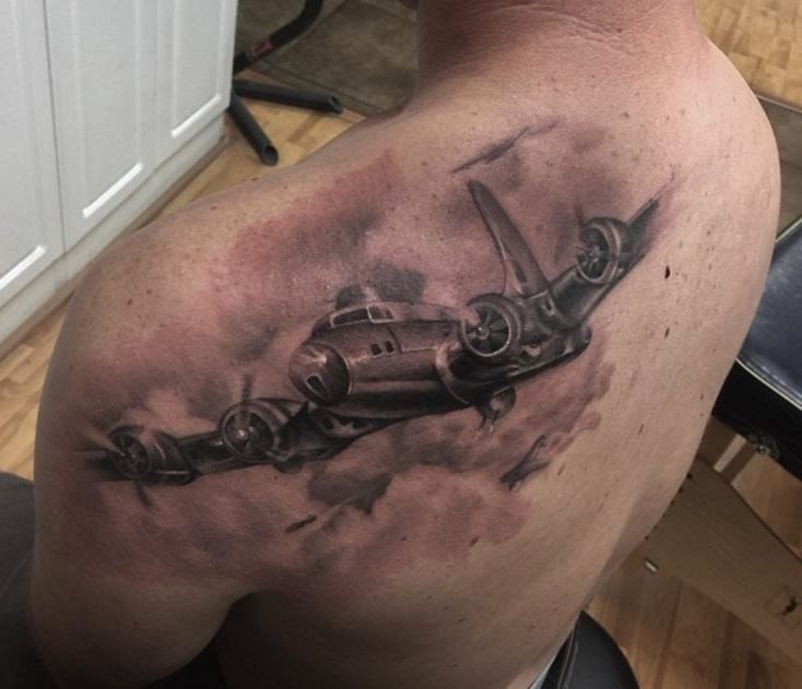 Black and gray style amazing looking scapular tattoo of big bomber plane
