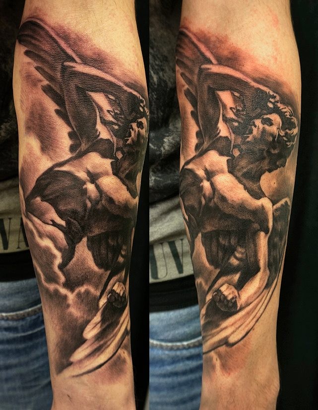 Black and gray style arm tattoo of big stone angel statue