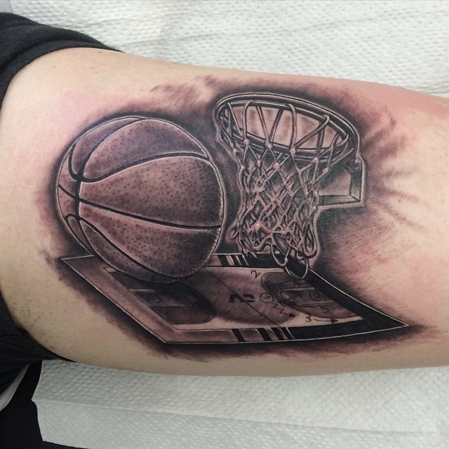 Black and gray style biceps tattoo of basketball net