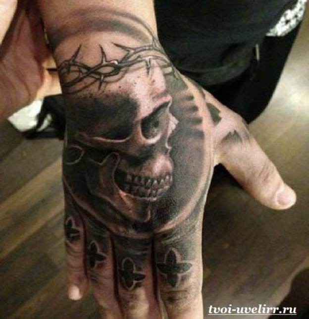 Black and gray style colored hand tattoo of human skull with vine