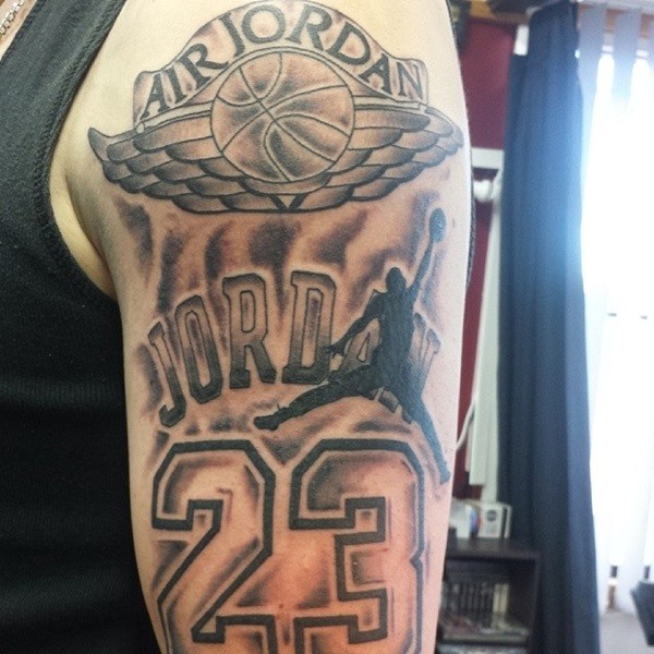 Black and gray style colored Jordan memorial tattoo on shoulder