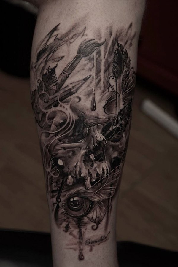 Black and gray style colored leg tattoo of human skull with eye and wings