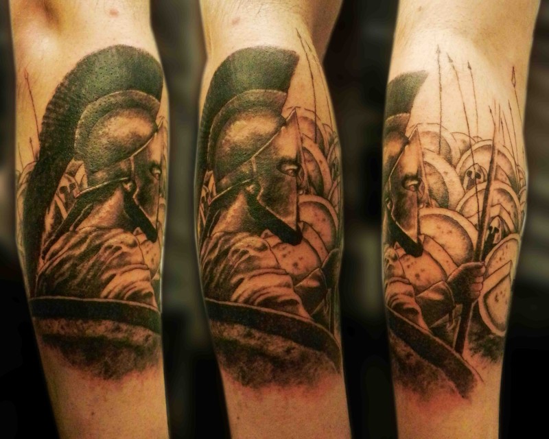 Black and gray style detailed arm tattoo of Spartan warriors