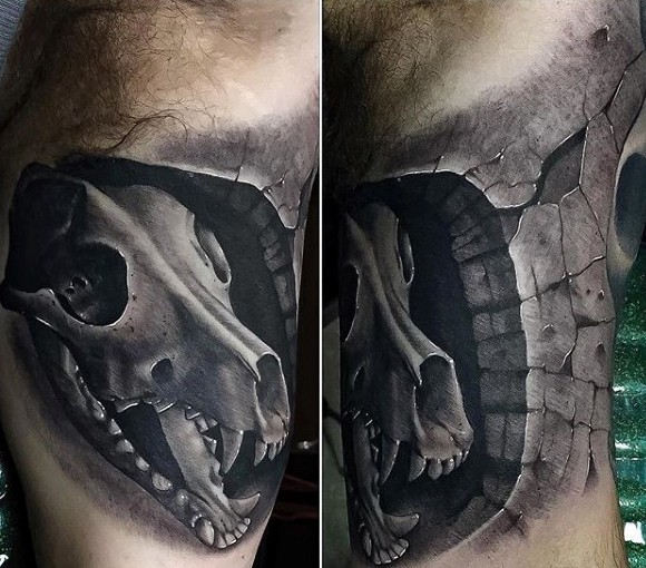 Black and gray style detailed biceps tattoo of human skull
