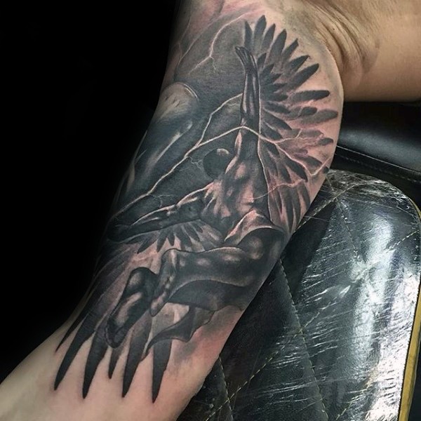 Black and gray style detailed biceps tattoo of flying Icarus with lightning