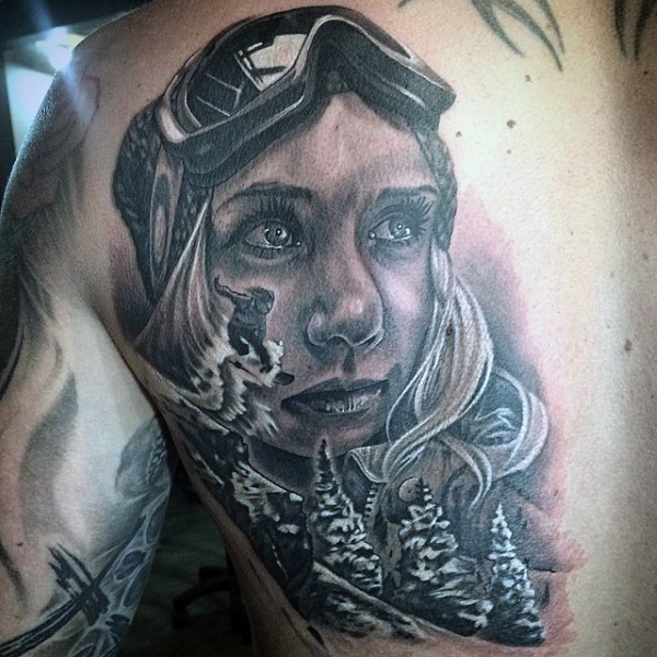 Black and gray style detailed scapular tattoo of woman snowboarder