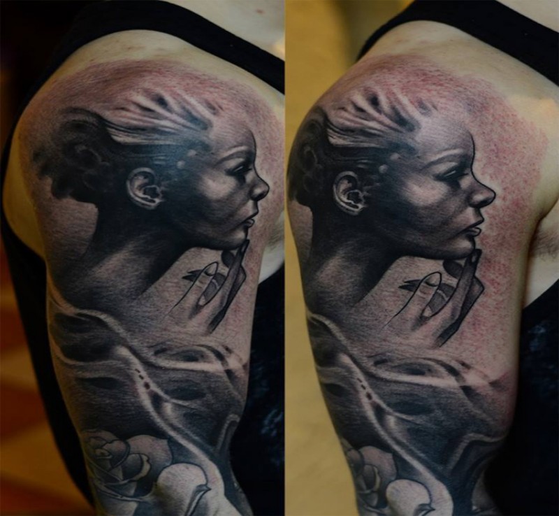 Black and gray style detailed shoulder tattoo of woman face with smoke and rose