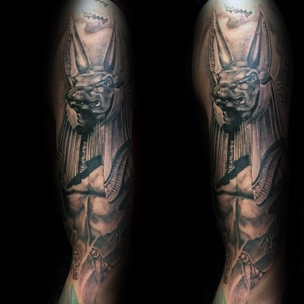 Black and gray style detailed sleeve tattoo of Egypt God statue