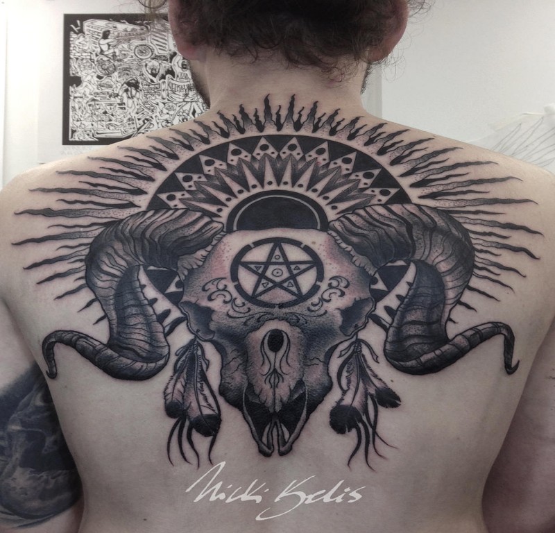 Black and gray style detailed upper back tattoo of cool demonic skull with sun and symbols