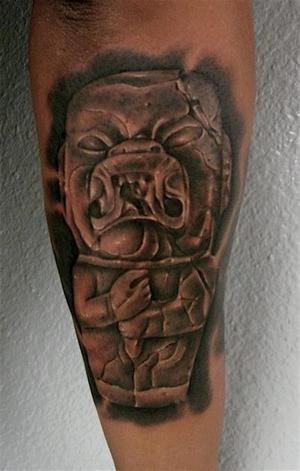 Black and gray style forearm tattoo of antic stone statue