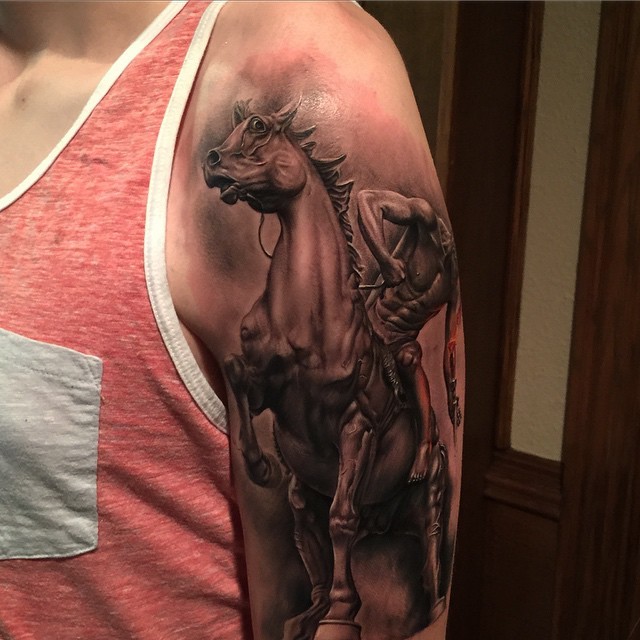 Black and gray style incredible looking shoulder tattoo of horse rider