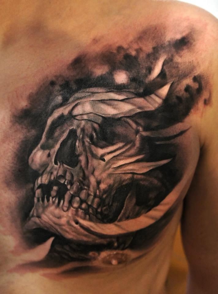 Black and gray style incredible looking chest tattoo of ancient skull