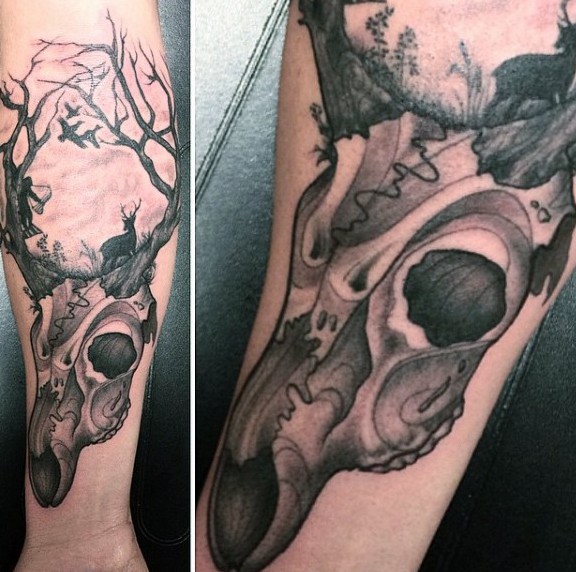 Black and gray style interesting designed forearm tattoo of deer skull with birds