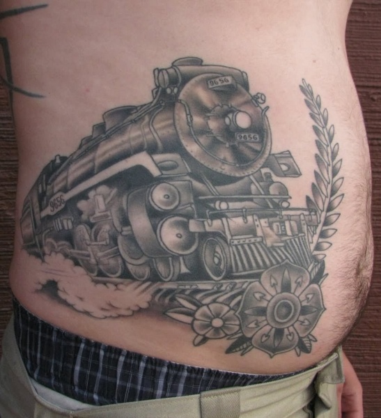 Black and gray style large belly tattoo of steam train with flowers
