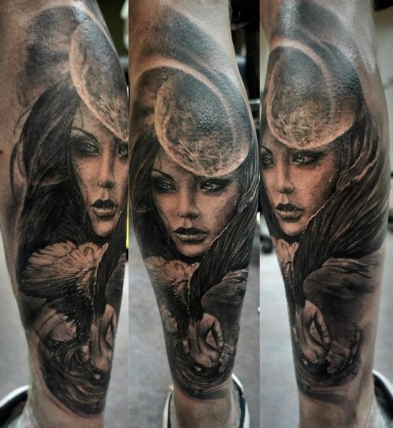 Black and gray style mystical looking leg tattoo of woman with moon