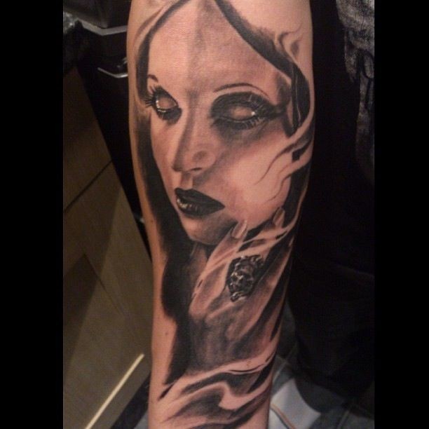 Black and gray style mystical woman portrait tattoo on forearm