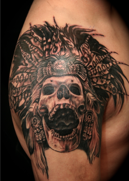 Black and gray style shoulder tattoo of ancient tribal skeleton with helmet